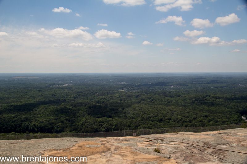 Wooded horizon beyond the granite slope