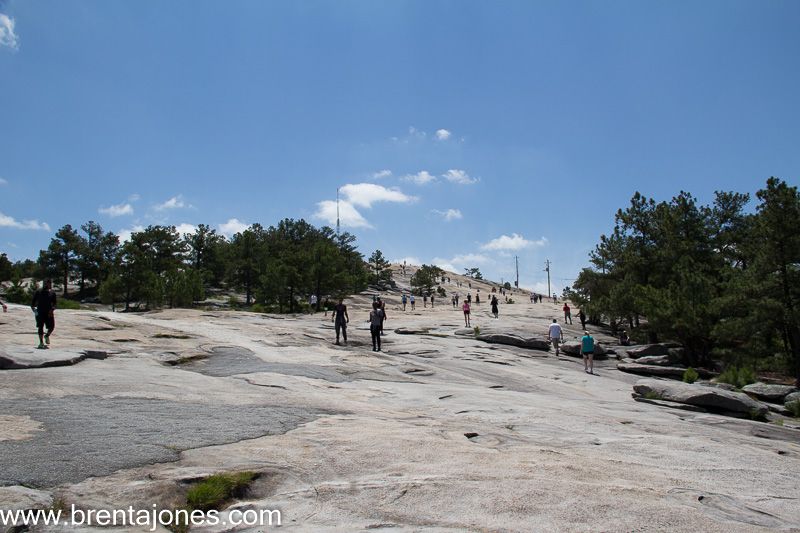 Walkers cross the open granite summit